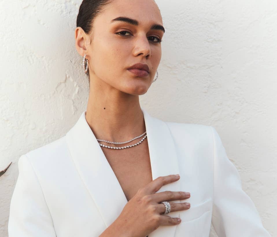 Female model wearing Tacori rings, earrings, and necklace