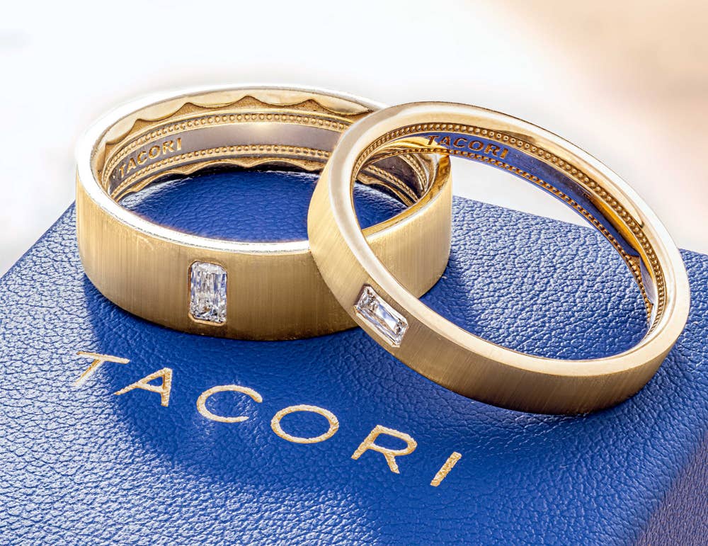 Two yellow gold wedding bands resting on TACORI blue box