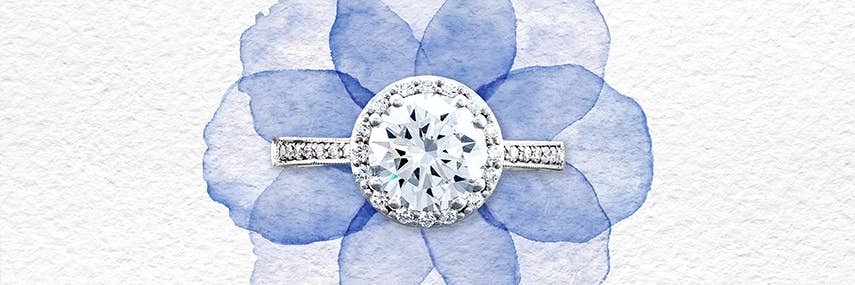 TACORI round engagement ring in platinum resting above a watercolor flower